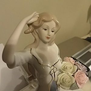 Lovely statue of a young woman with flowers.